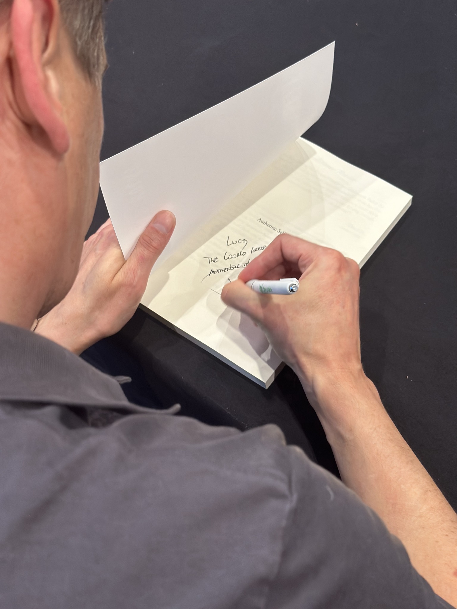 Peter writing a personal inscription