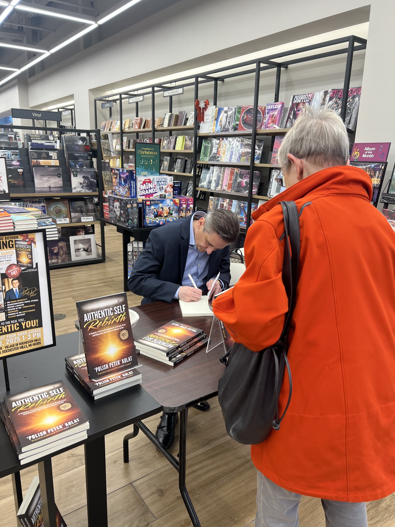 Peter signing a book for a reader