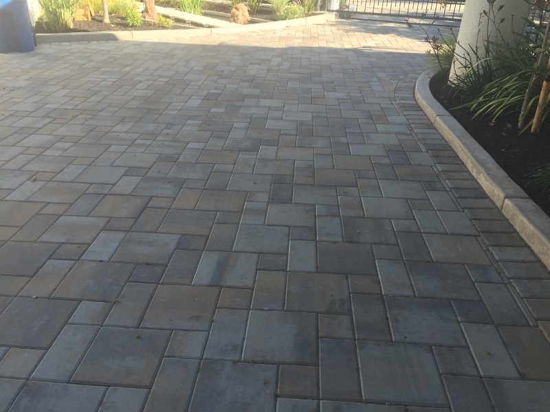 A beautifully finished stamped concrete patio in a backyard