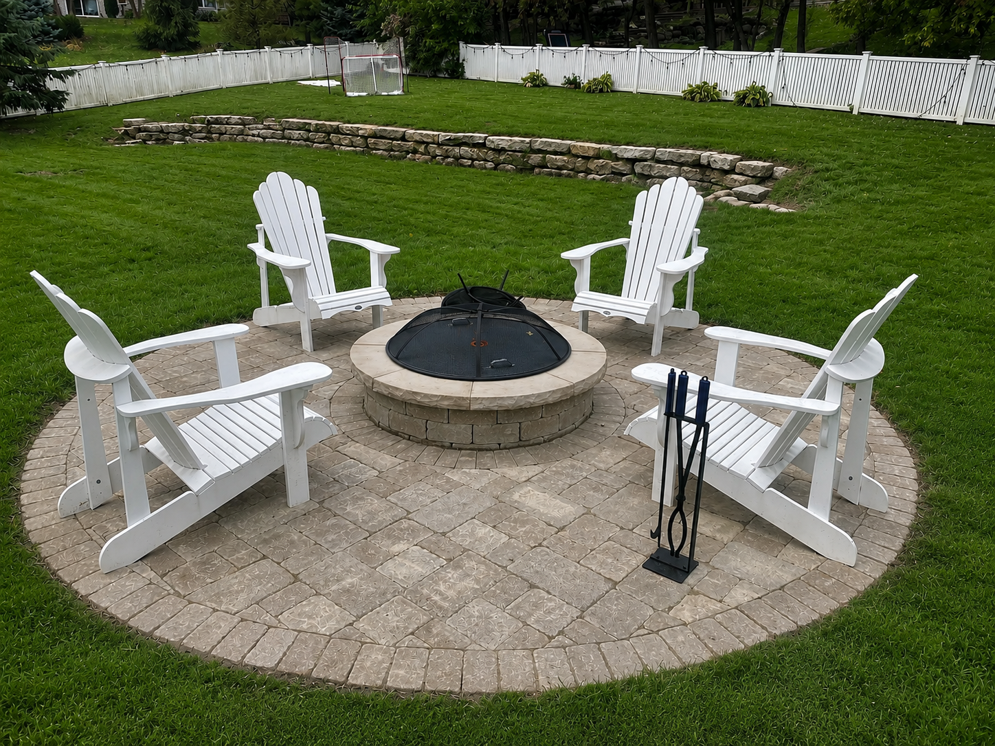 Paver steps with a landing leading to a white door on a dark blue house.