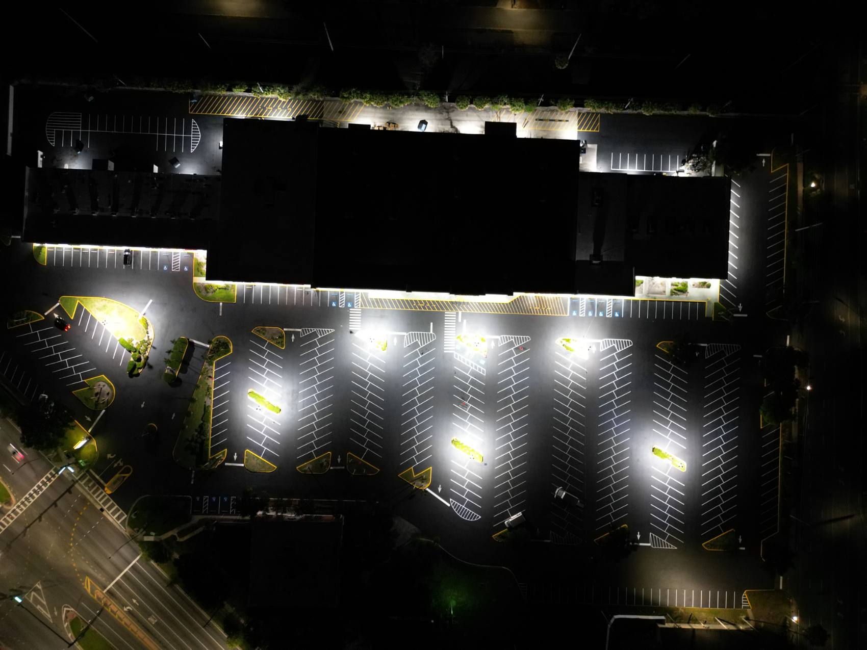 Freshly striped commercial parking lot at night