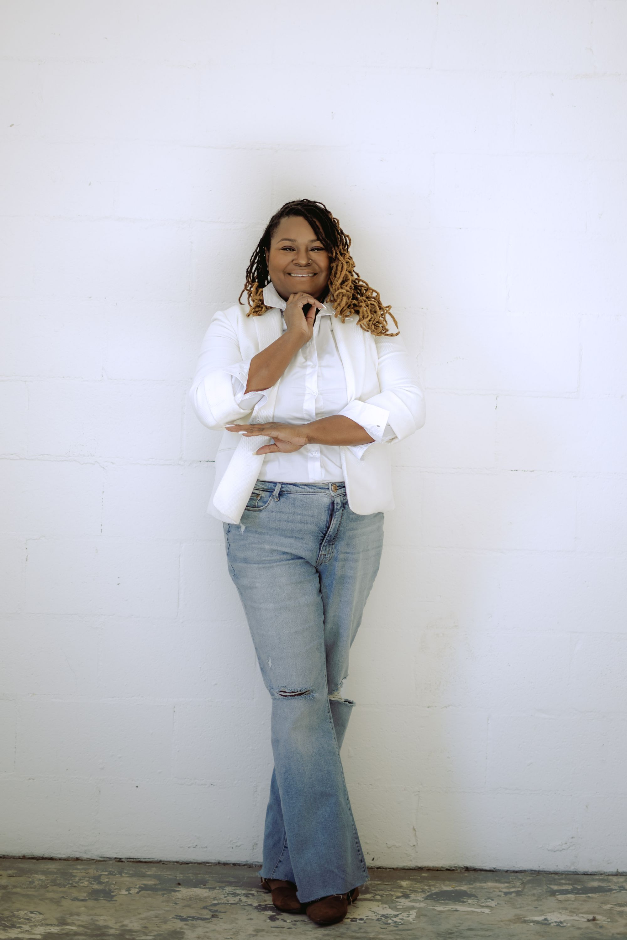 Starr Clinton smiling in a white blazer