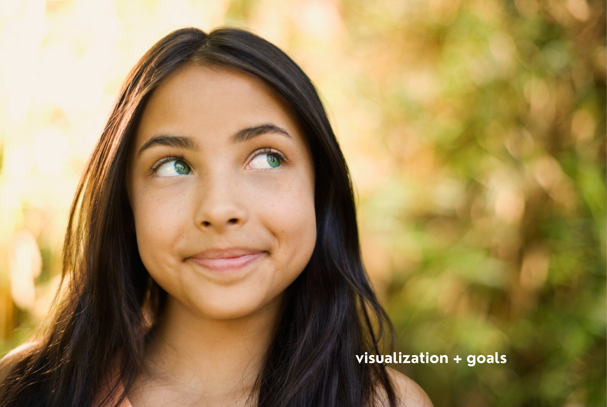A teen or tween girl with tan skin and long, straight brown hair stands outside in the sun, visualizing her goals.