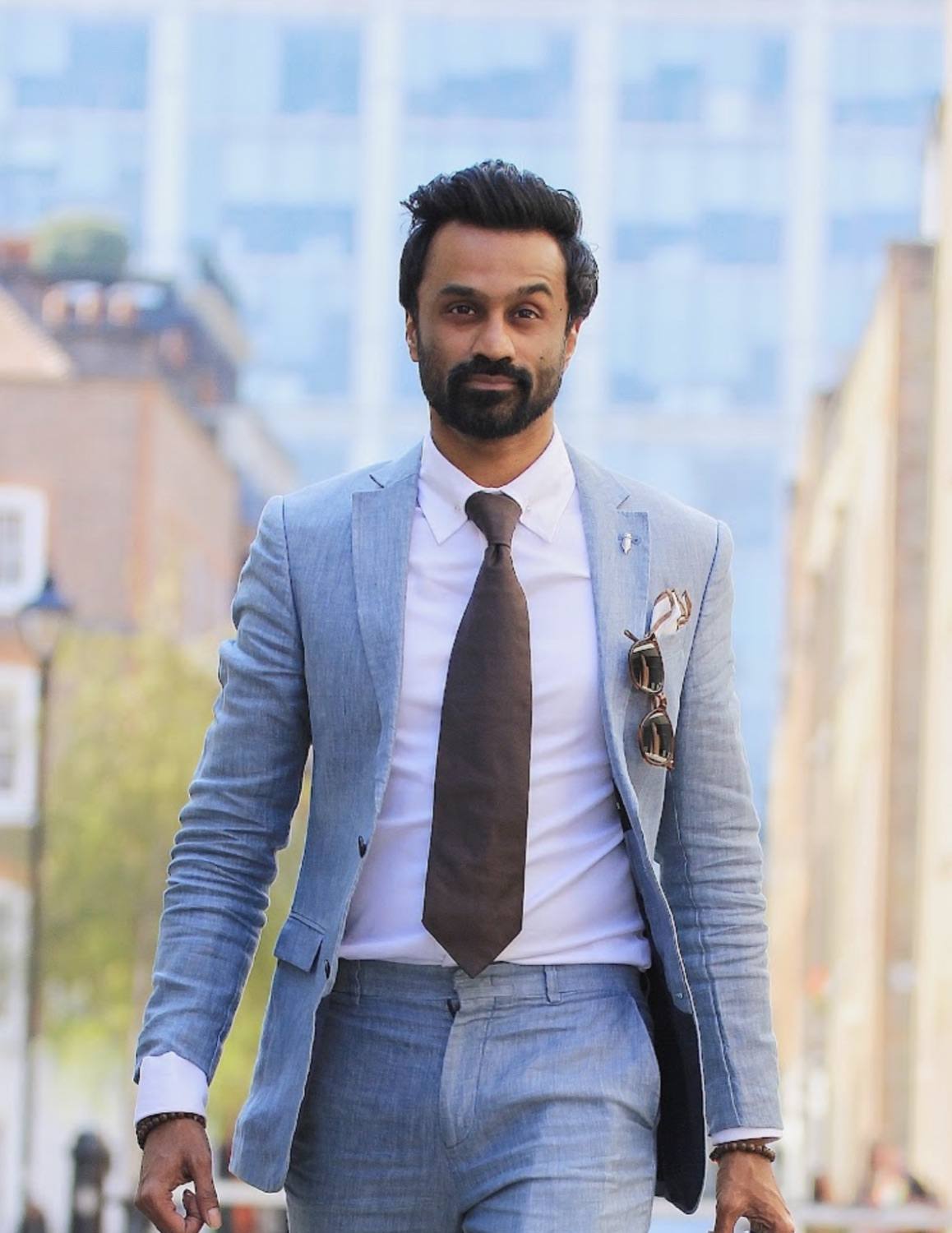 Dr Neel Reddy walking in the City of London