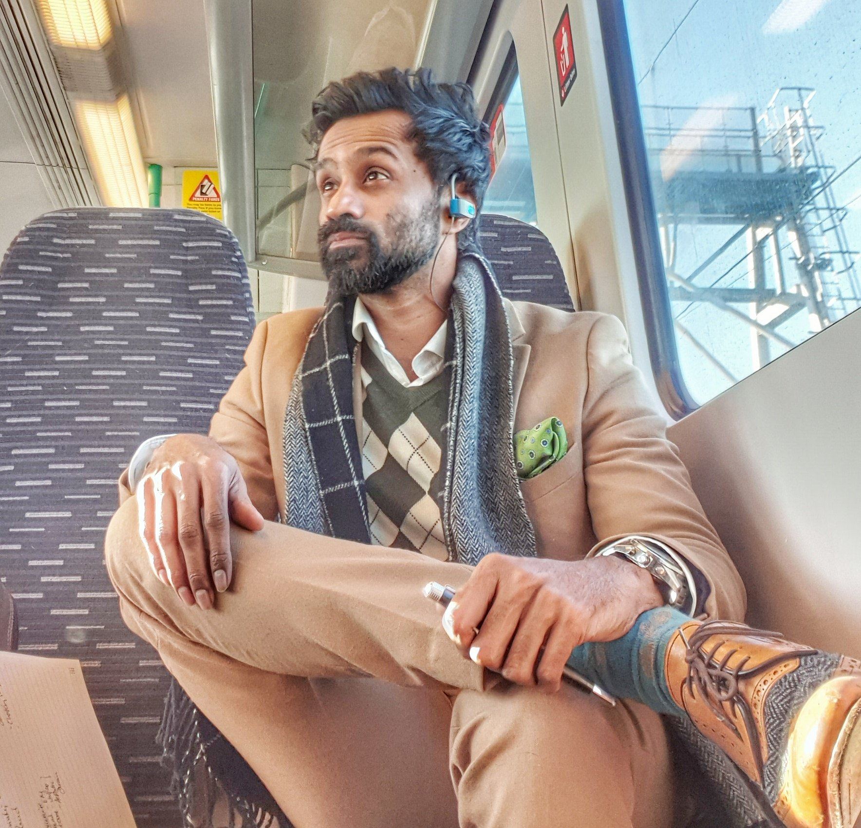 Dr Neel Reddy on a train, looking out of the window
