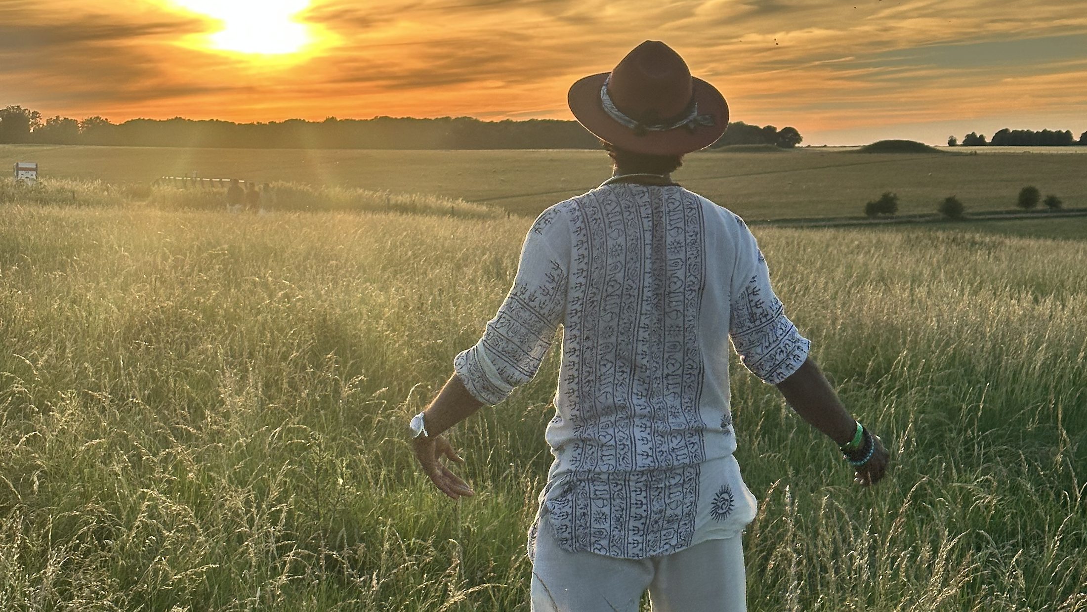Dr Neel Reddy walking into a field at sunset