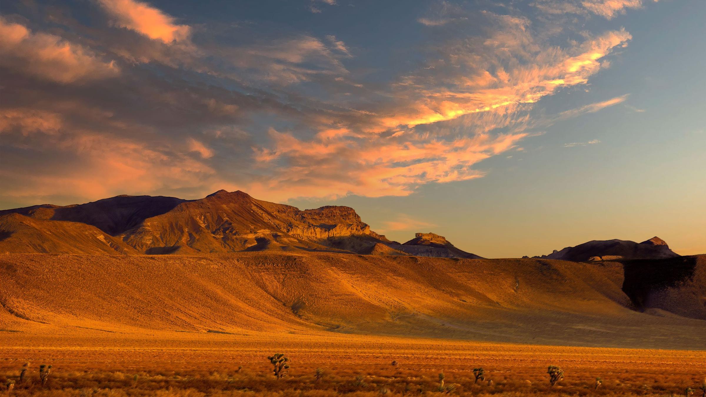Sunset light on a desert mountain range above a wide valley in the Great Basin