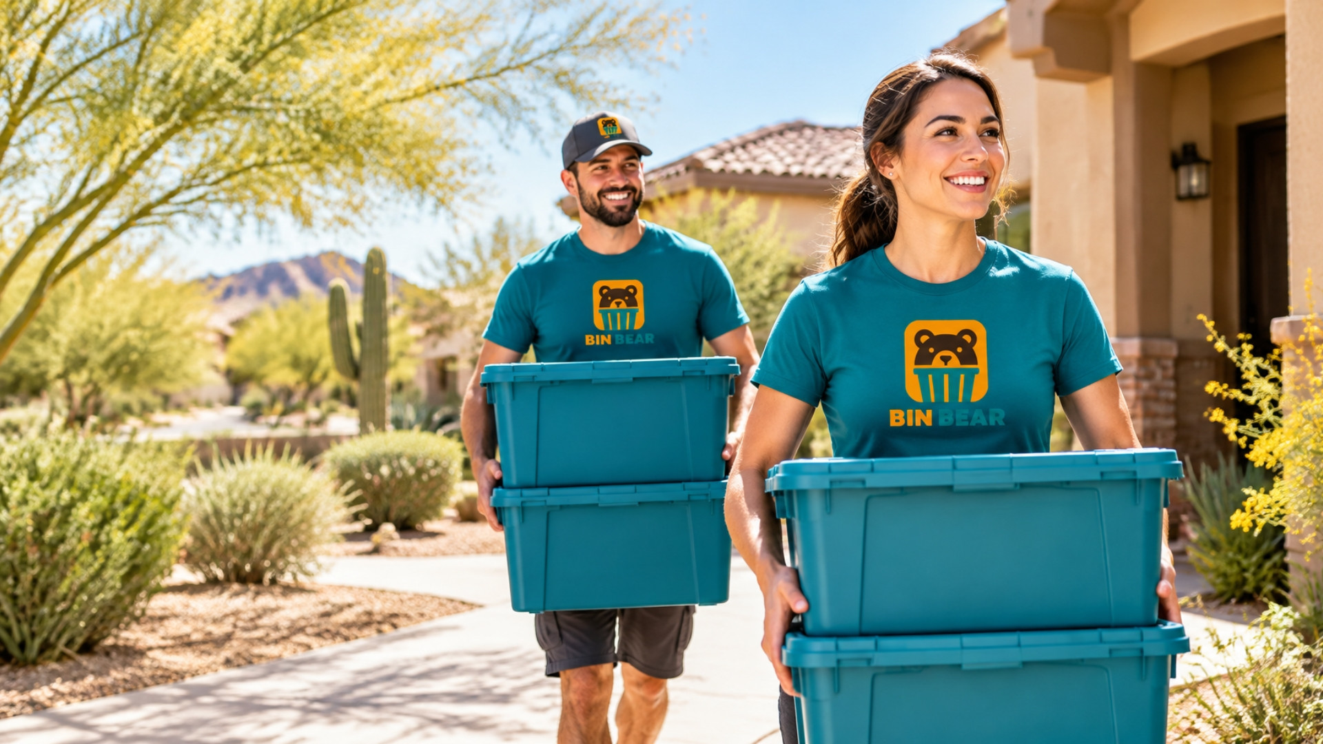 Two Bin Bear movers carrying teal bins up a Phoenix driveway