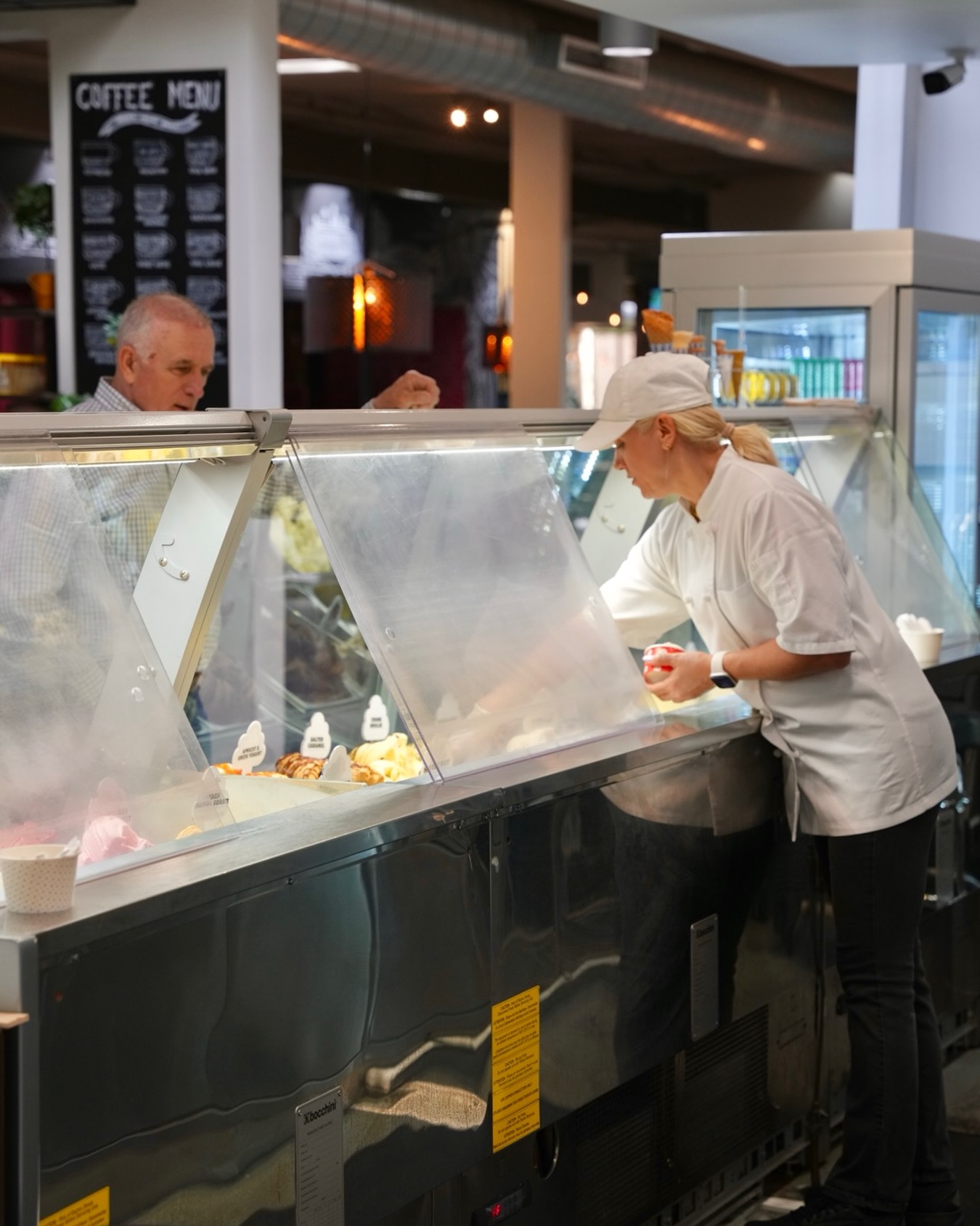 Scooping gelato at the GB Gelato display case