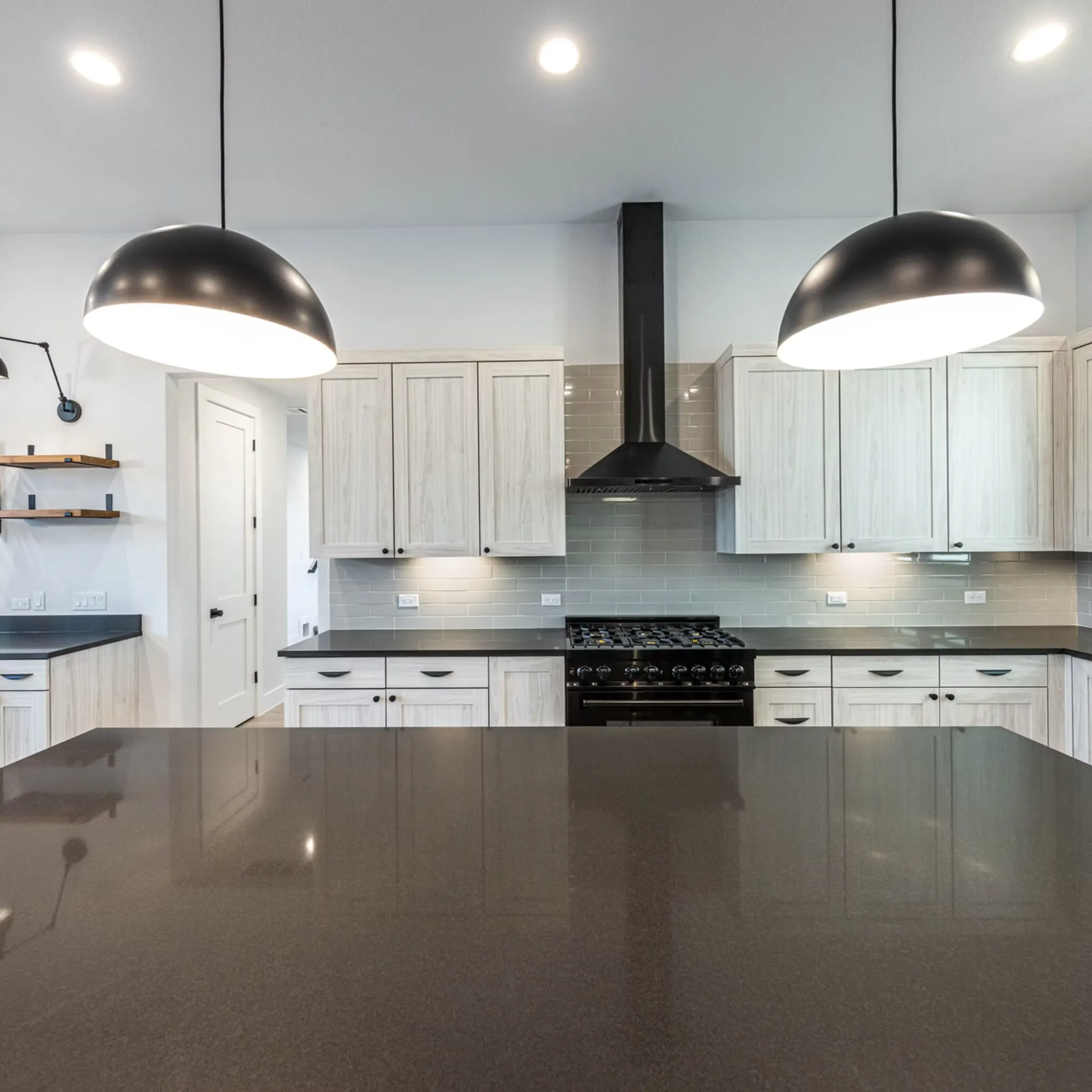 Flawlessly installed quartz countertop in a modern Austin kitchen featuring veined surface, sleek cabinetry, natural daylight.