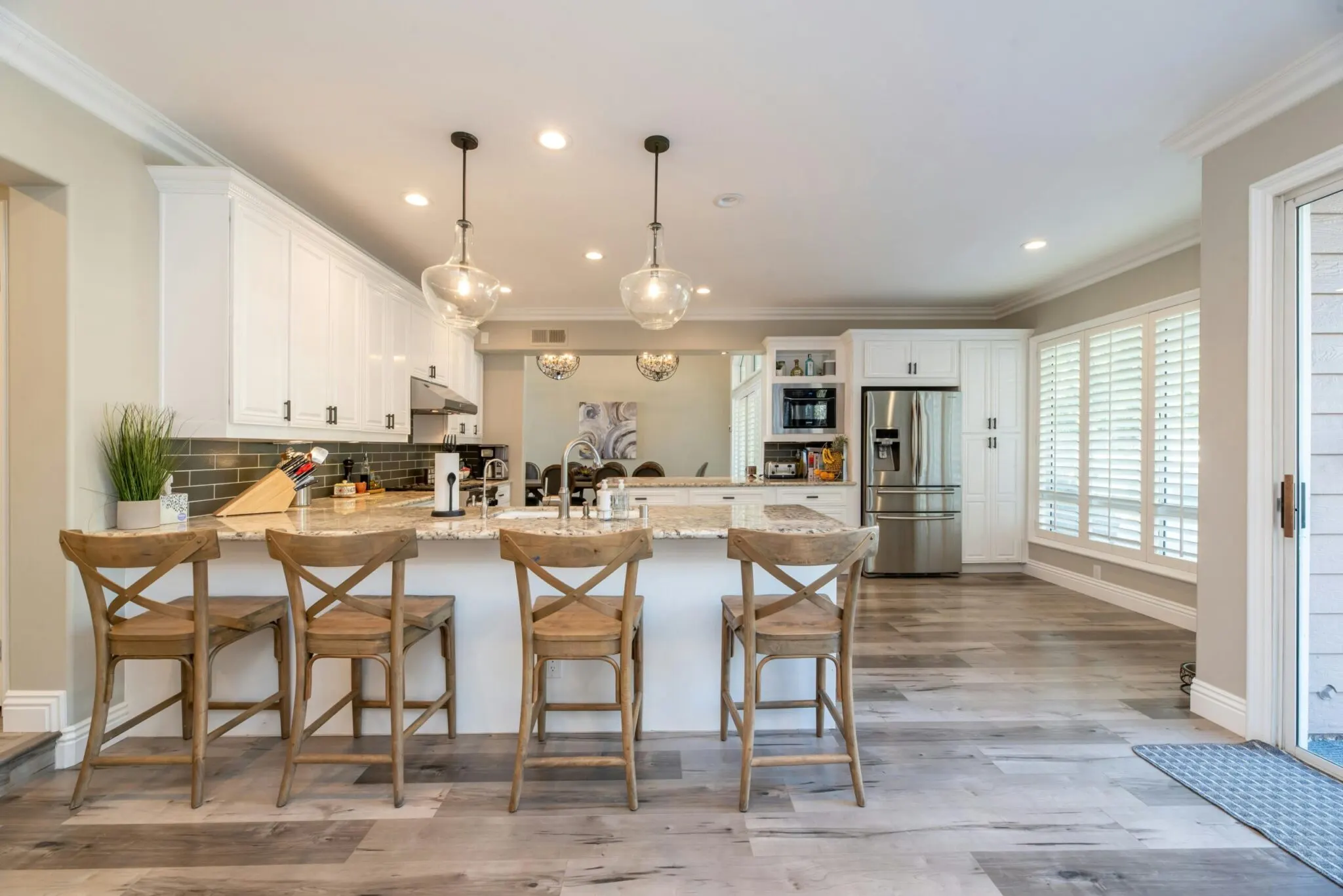 Modern kitchen remodel in Crestview TX with quartz counters, stainless steel appliances, and warm inviting lighting.