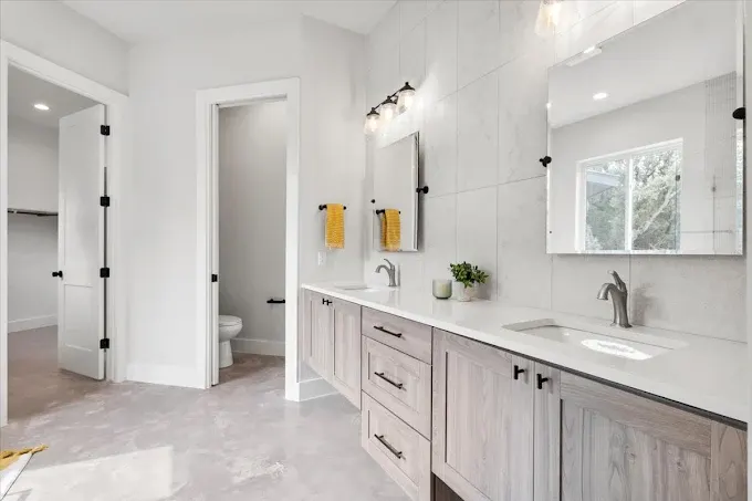 Beautifully remodeled kitchen in Zilker, TX with walnut cabinetry, quartz countertops, and spacious living area.