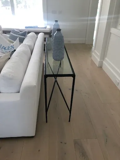 Completed wood flooring installation in Golden Gate, FL, showcasing rich hardwood planks and elegant decor elements.