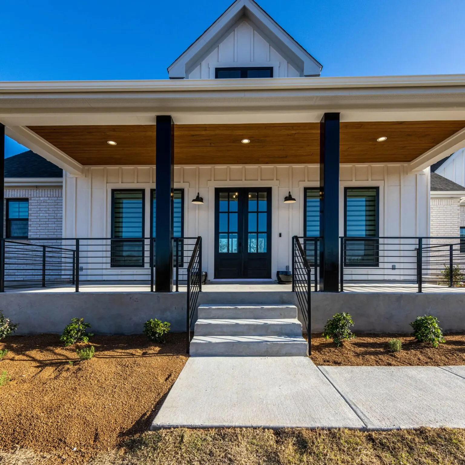 Renovated modern Austin living room with sleek furniture plush sofas panoramic Texas skyline view hardwood floors