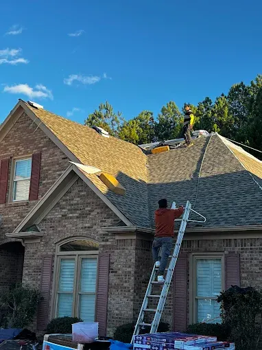 Freshly completed roof installation in Trussville, AL, featuring gray shingles, a suburban home, and a picturesque neighborhood.