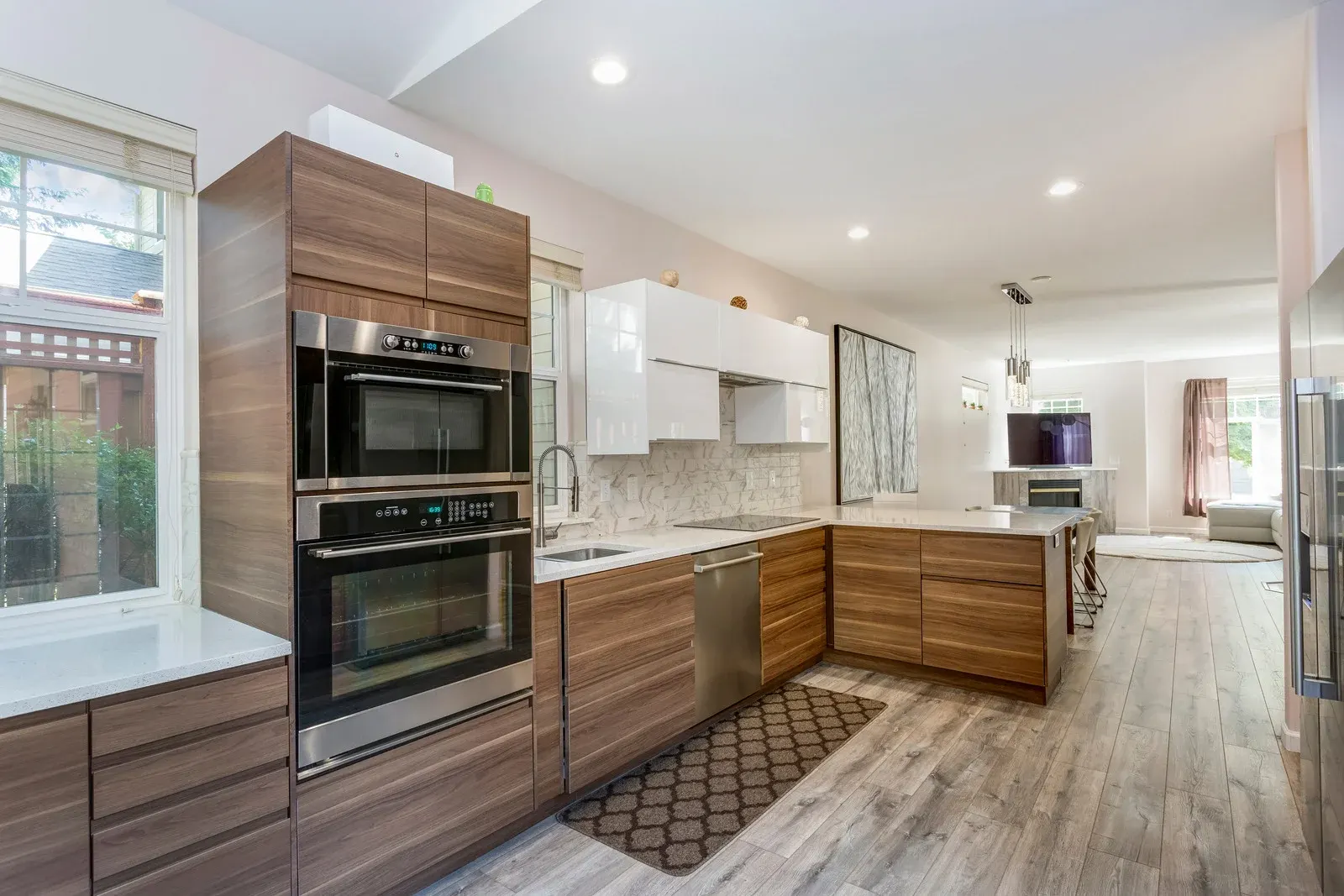 Modern kitchen remodel in Fort Worth with warm wood cabinetry, stainless steel appliances, and sleek granite island.