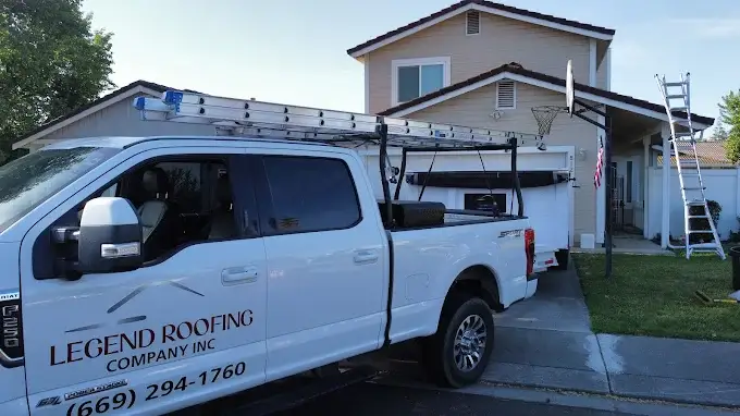Close-up of a freshly repaired skylight flashing on a modern residential roof with shingles, trees, and blue sky in Modesto California