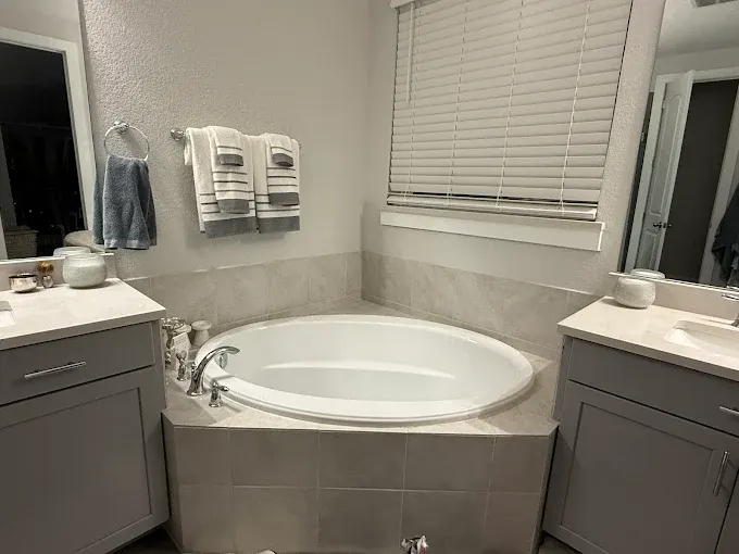 Renovated kitchen in Austin featuring sleek cabinetry, granite island, stainless steel appliances, and natural light.