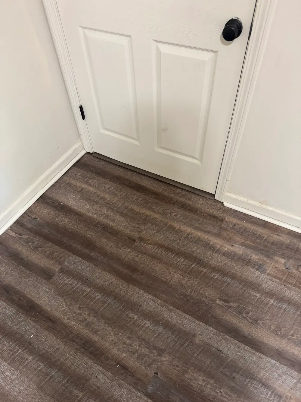 Elegant hardwood flooring installation in a modern room with warm tones, polished finish, and stylish decor.