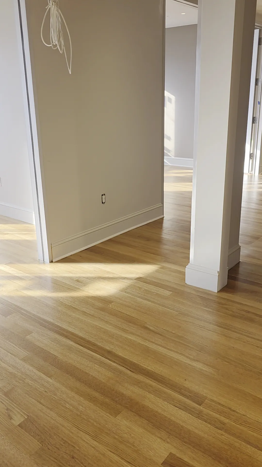 LVP flooring installation in a spacious living room with warm wood tones, stylish decor, and natural light.