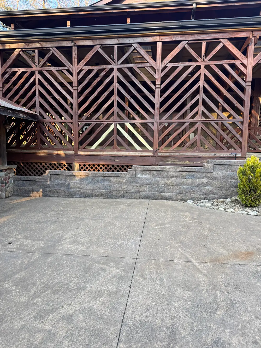 Newly installed wrought iron gate in Cohutta GA, detailed design, surrounded by a wooden fence and landscaped garden.