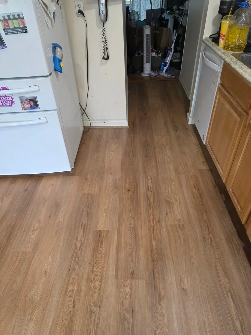 Completed laminate flooring installation in Centreville VA featuring herringbone pattern and elegant decor in a bright living area.