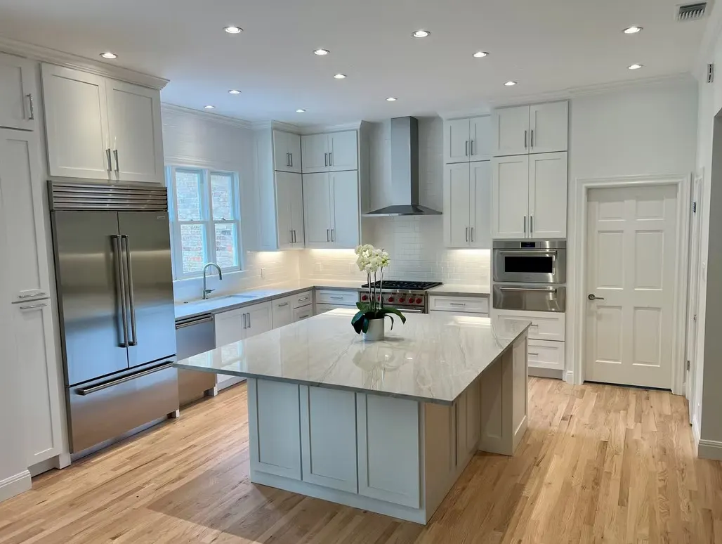 Completed modern kitchen quartz countertop with natural veining, seamless joints, glossy finish, and minimalist decor