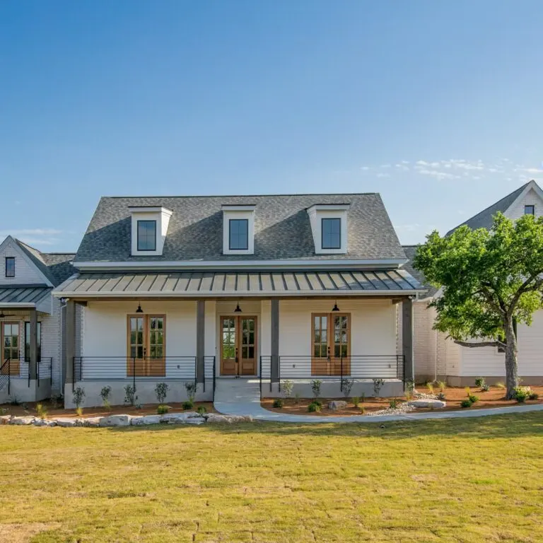 Elegant kitchen remodel in Volente TX features custom cabinetry, large island, stainless appliances, and ambient lighting.