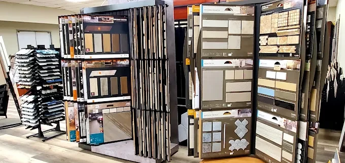 Modern flooring showroom in Oklahoma City featuring hardwood, laminate, tile, and carpet displays in an inviting space.
