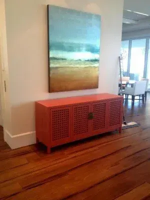 Cozy living space in Chokoloskee FL with hardwood flooring, neutral furniture, and coastal artwork creating warmth.