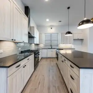 Beautifully renovated living room in Falconhead TX featuring modern decor, natural light, and serene outdoor views.