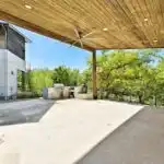 Finished cedar deck with detailed craftsmanship in a lush Austin suburban yard under clear blue sky