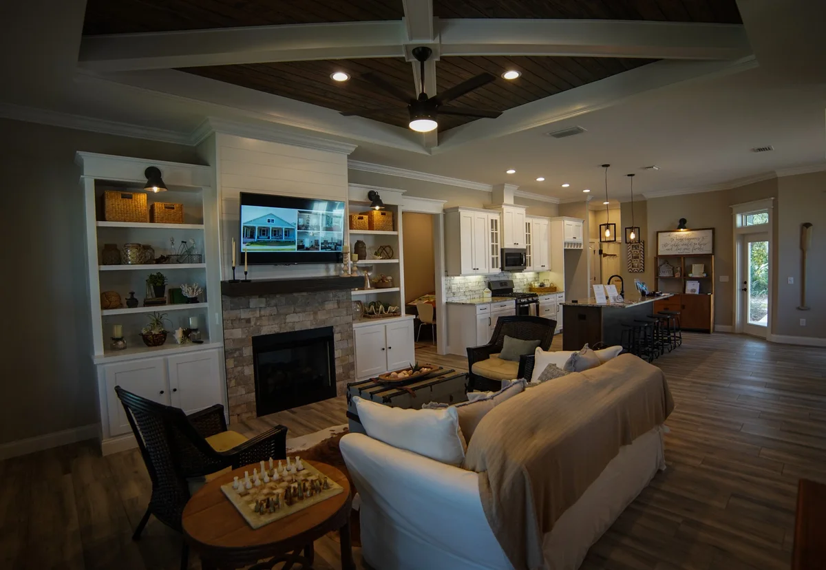 Modern kitchen in New Smyrna Beach with freshly painted cabinets, elegant lighting, and polished wood flooring.