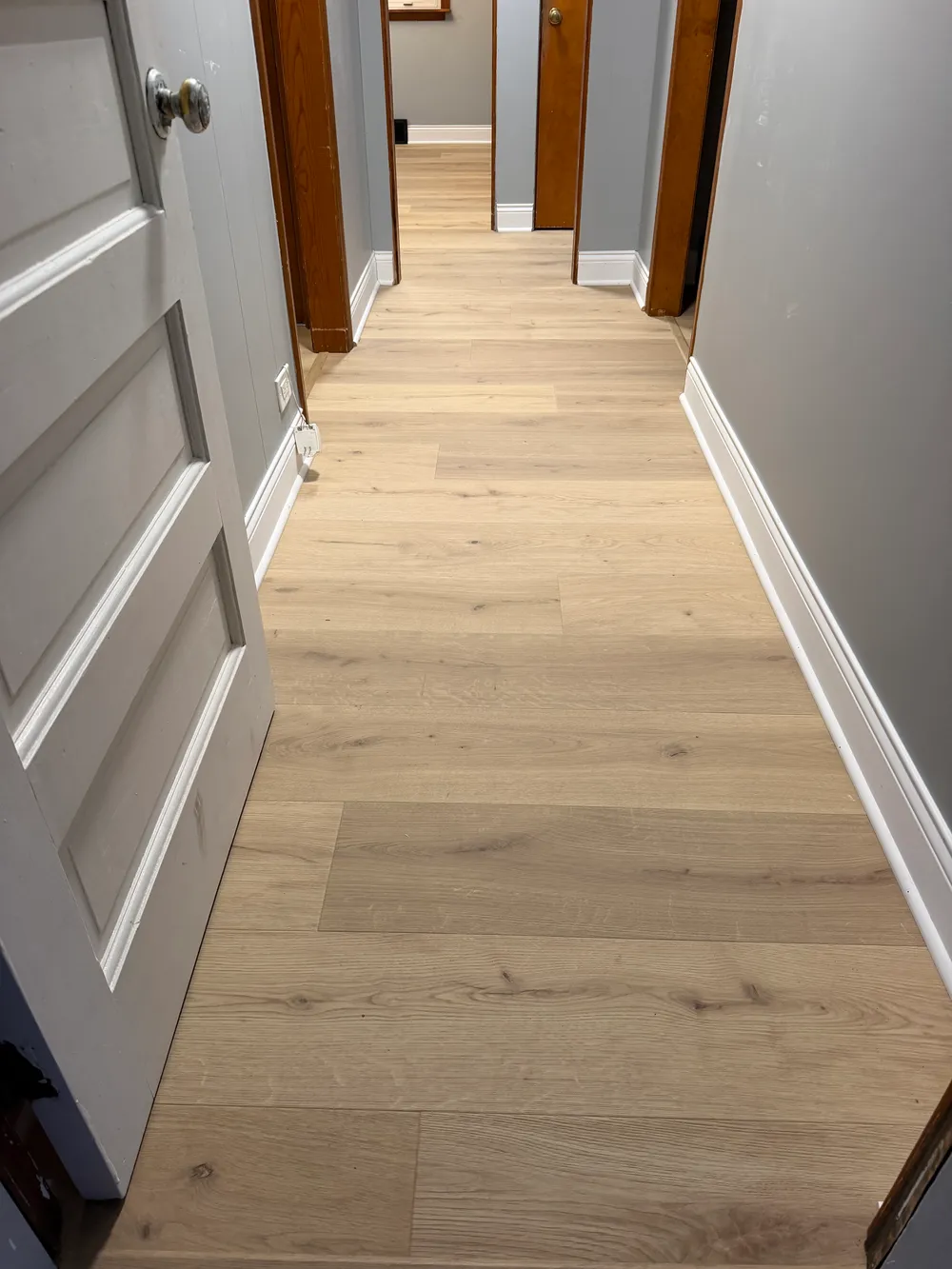 Self-leveling underlayment installation in Darien IL with smooth light gray surface and neatly arranged tools.