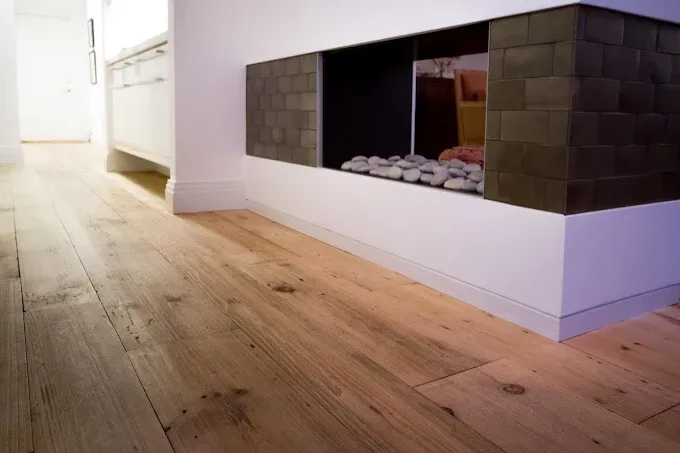 Hardwood floor gap repair in a modern living room on Naples, showcasing rich wood tones and expert craftsmanship.