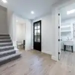Modern kitchen remodel in Holly TX with elegant cabinetry, natural light, and cozy dining area featuring hardwood floors.