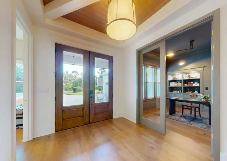 Spacious living room in Waters Edge FL with neutral walls, white trim, and stylish decor, showcasing elegant interior painting.