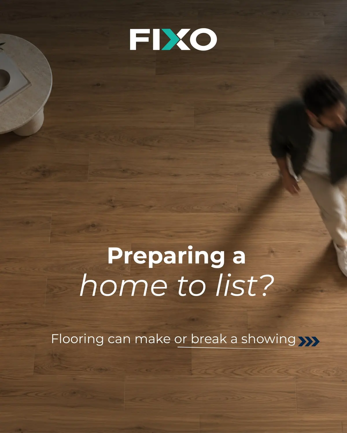 Overhead view of a man walking on new wood flooring, with 