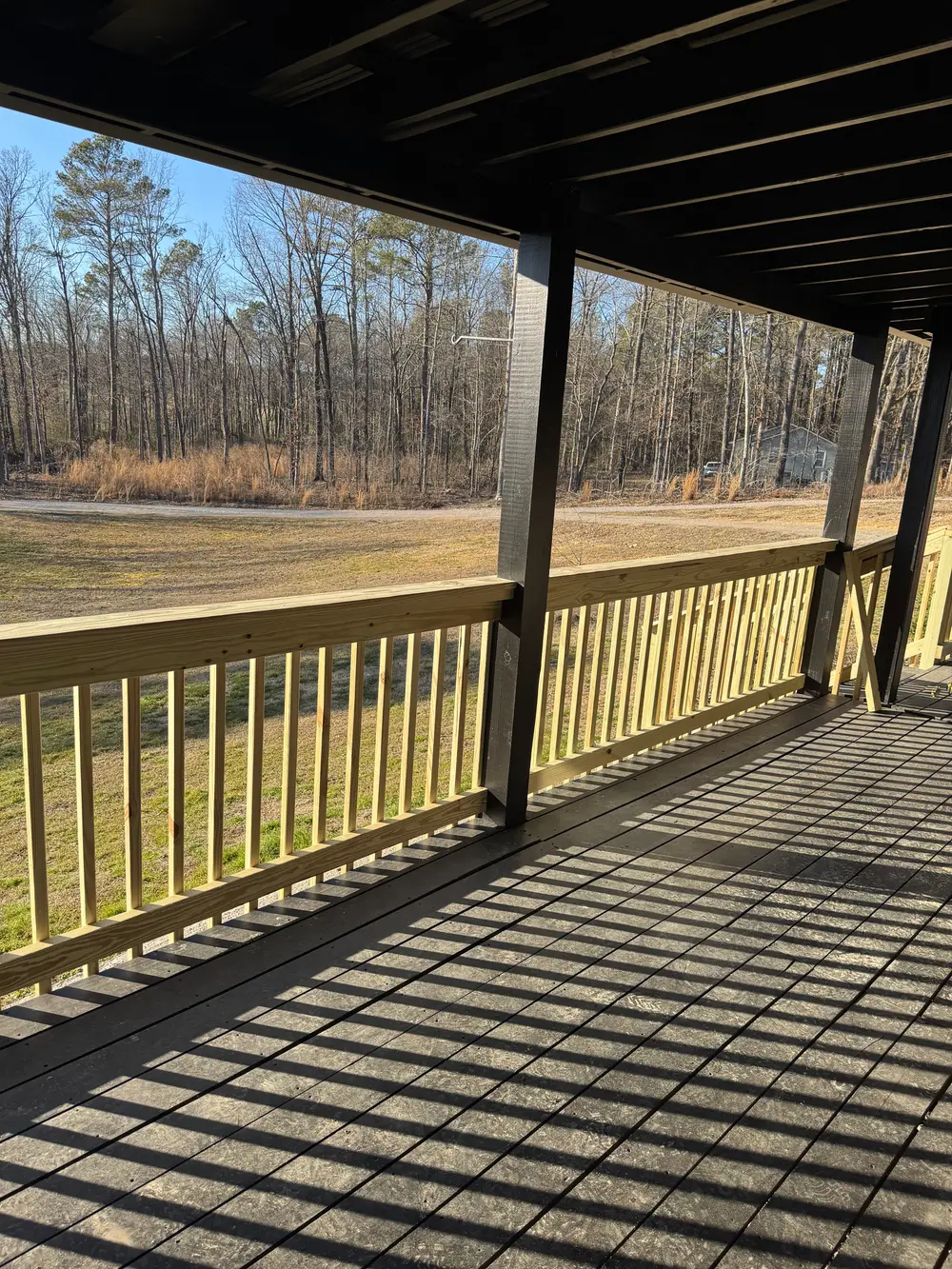 Completed patio in Cohutta GA featuring stone pavers, modern furniture, greenery, and mountain backdrop.