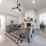 Modern garage conversion in Austin with polished wood floors, neutral walls, natural light, contemporary decor, and stylish functional space