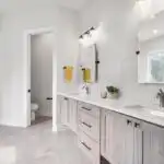 Refurbished kitchen cabinets in Austin with flawless wood finishes, sleek hardware, modern backsplash, and natural light.