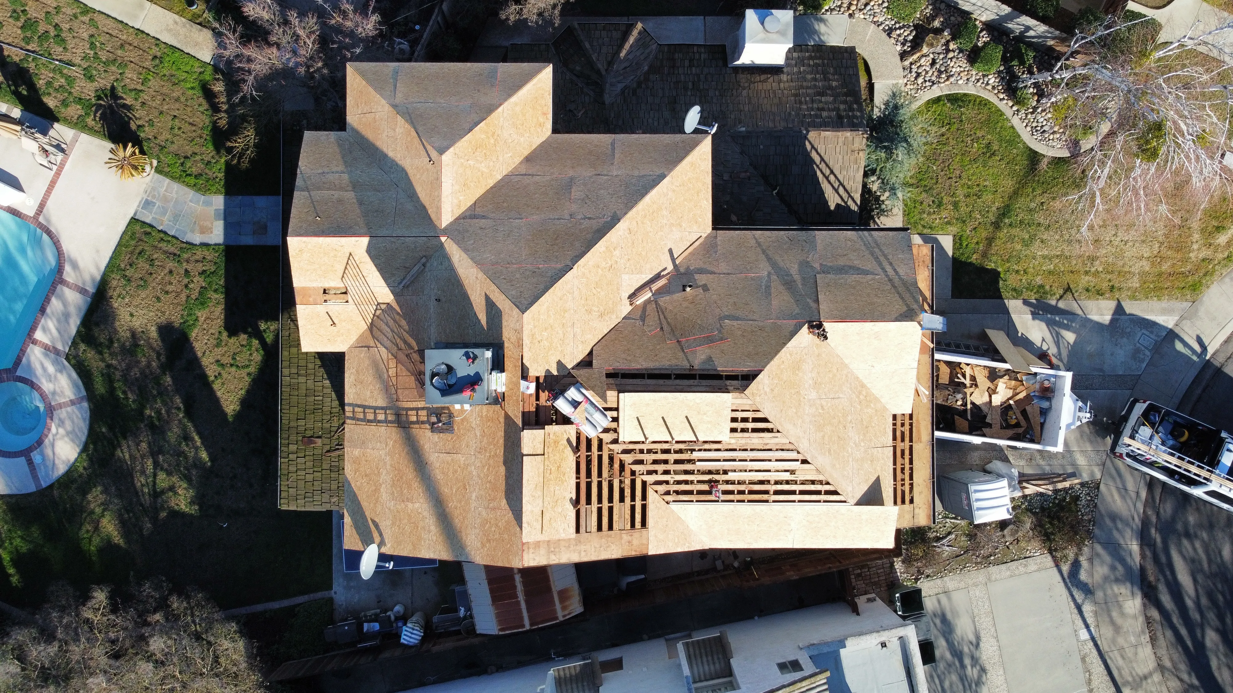 Freshly completed roof replacement on a modern home in Modesto CA showcasing textured asphalt shingles and vibrant landscaping.