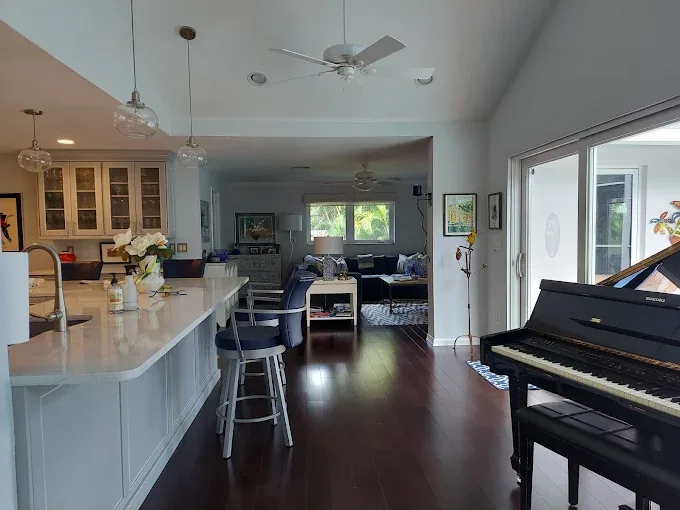 Hardwood floor gap repair in Naples FL showcases seamless integration and flawless craftsmanship in natural light.