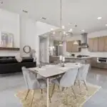 Renovated modern Austin kitchen with natural wood cabinets, marble countertops, copper sink, geometric backsplash, and large windows