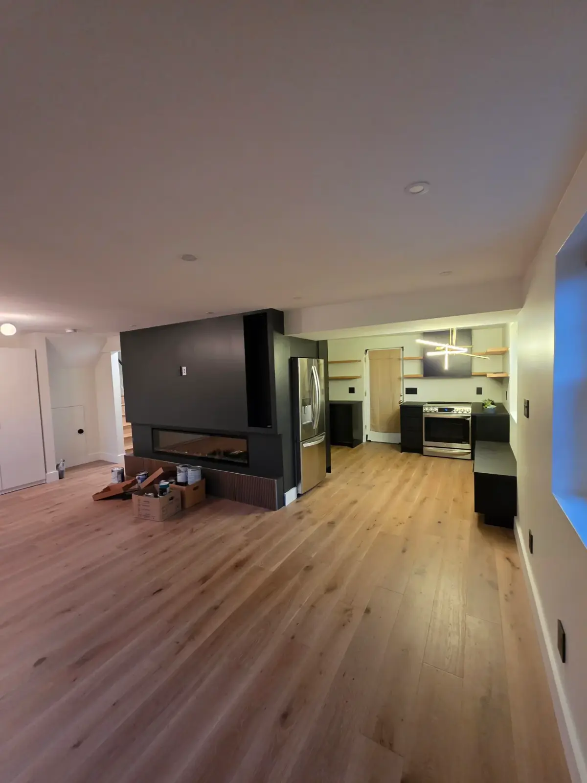 Completed flooring installation in Lincolnia, VA features hardwood, laminate, and luxury vinyl in a bright, airy space.
