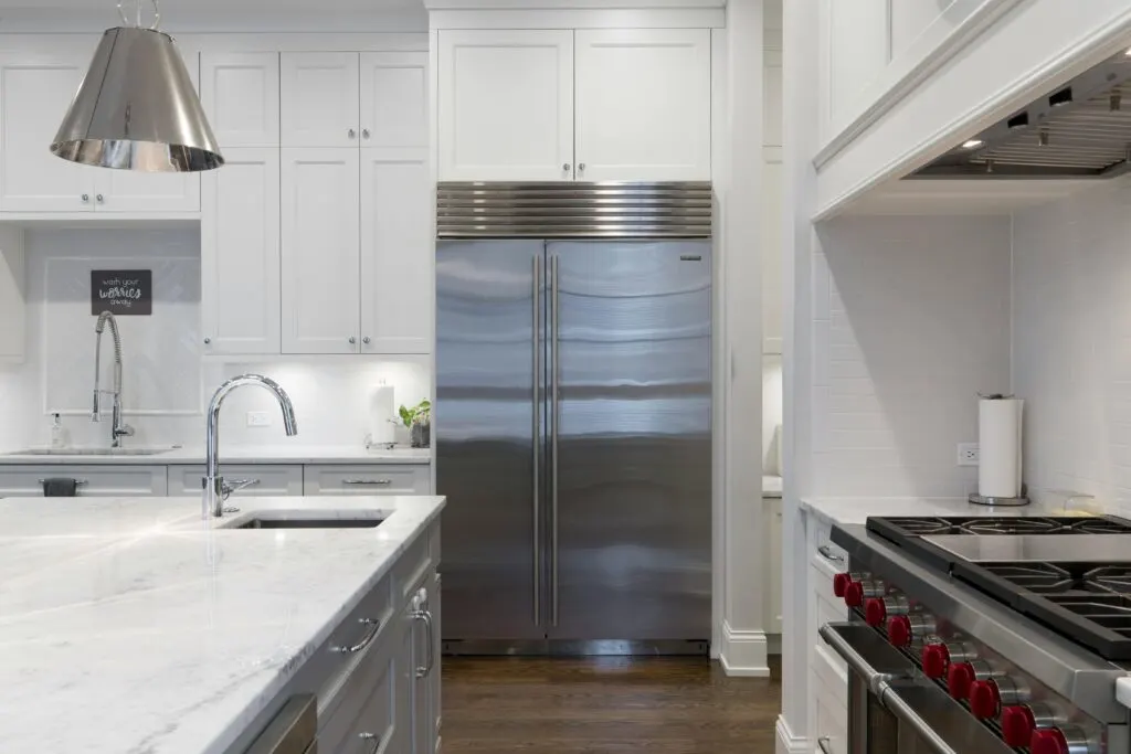 Home remodeling in Crestview TX features a modern living room with neutral decor, wood floors, and stylish kitchen.