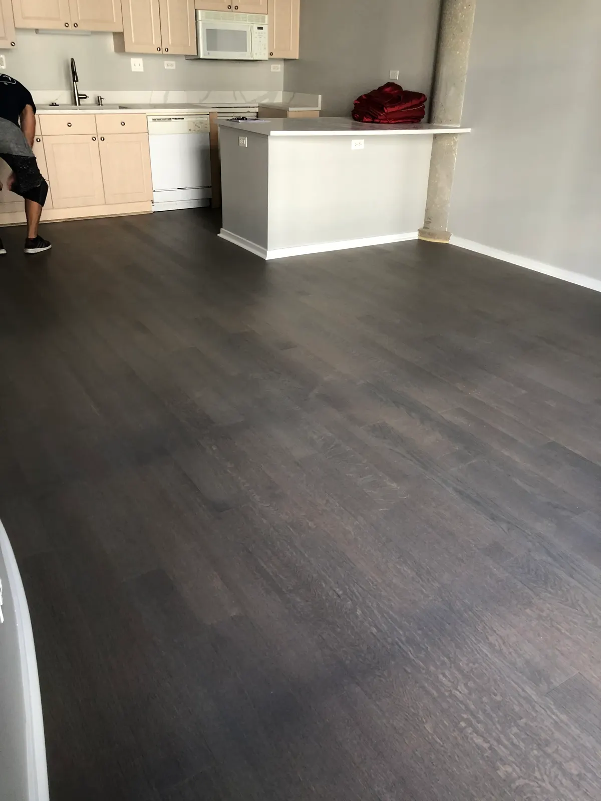 Self-leveling underlayment installation in Darien IL with a smooth surface, tools, and a clean, minimalistic room.