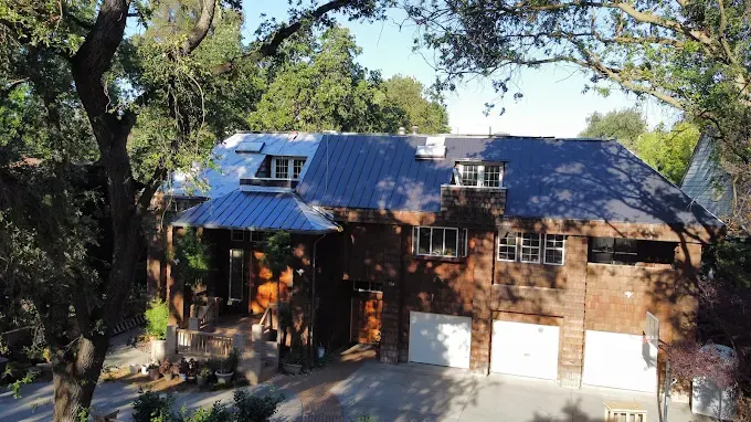 Completed black rubber pipe boot replacement on a residential roof in Modesto California with detailed shingles and clean craftsmanship