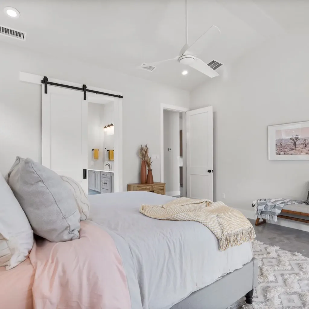 Renovated living room in Brentwood TX with modern design, hardwood floors, large windows, and sleek kitchen.