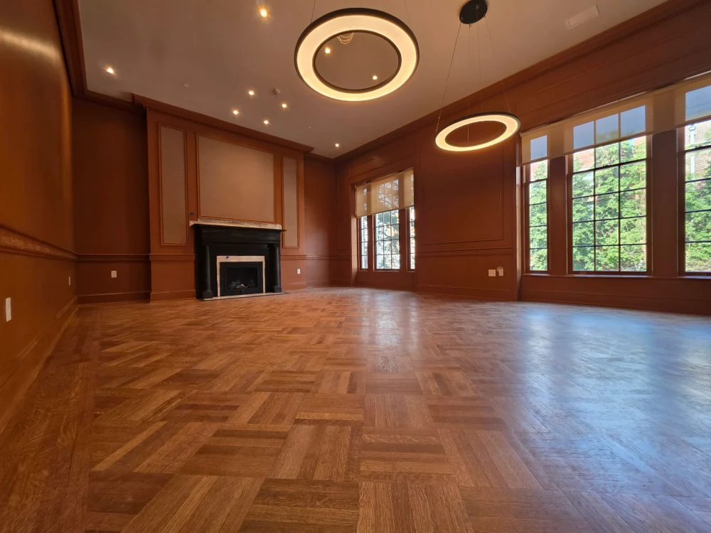 Spacious room in Centreville VA with dark hardwood flooring, large windows, and a soft color palette on walls.